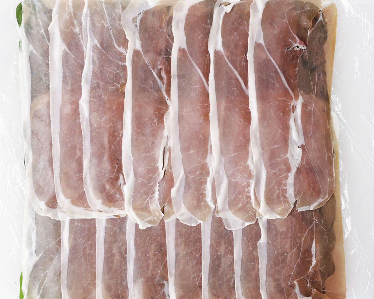 Laying out the Parma ham and spreading the duxelle